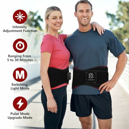 Couple wearing fitness waist trainer devices outdoors.