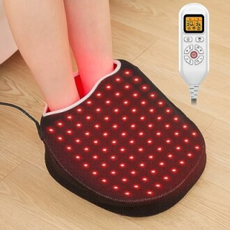 Person using a heated foot massager with LED lights and remote control.