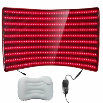 Red light therapy pad with remote and cushion.