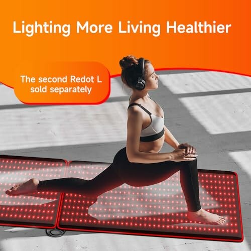 Woman stretching on a red light therapy mat.